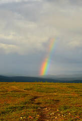 Kaunispää Saariselkä Finland. After the thunder, the sun shines again and a rainbow appears against the dark sky