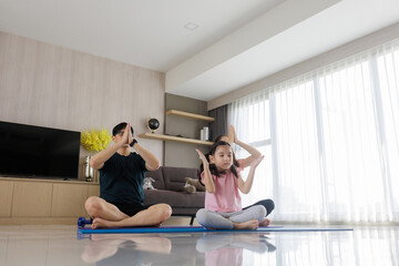 family Asian exercising at home together. Family doing yoga.