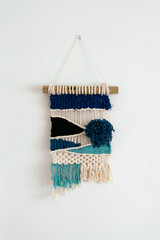 Textile Artwork Hanging On A White Wall