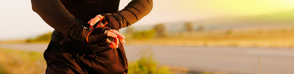 Smartwatch smart wearable tech gadget for fitness health active lifestyle. Fit young man using new sports watch on jogging run checking his heart rate banner panorama.