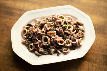 Italian calamari salad on white plate