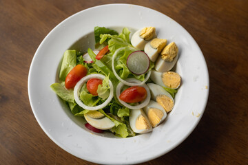 Vegetable salad and eggs on a white plate