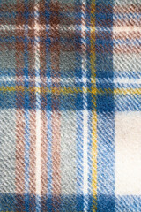 Woollen tartan Plaid Fabric, typical Scottich patterned cloth texture.