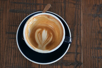 cup of coffee on wooden table