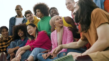 Diverse group of friends having fun outdoor - Multiracial young people celebrating together - Powered by Adobe