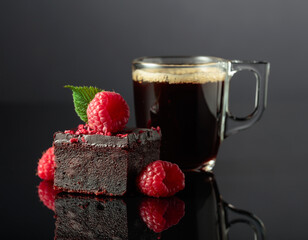Chocolate cake with fresh raspberries and black coffee.