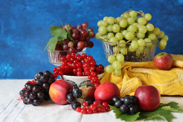 Fototapeta na wymiar Colorful still life with seasonal fruit and berries on textured background with copy space. Balance diet concept. 