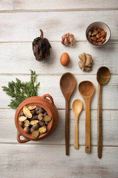 Brown Earthy Kitchen Cooking Utensils On Wooden Floor