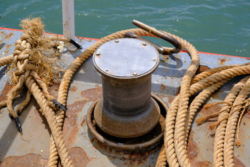 Fototapeta premium Close up of Old ropes and rusty bollard. rope and Marina bollard on moorage. The concept of mooring and water transportation