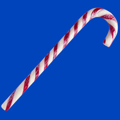 Christmas Candy Cane close-up isolated on blue background