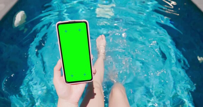 girl use phone on pool