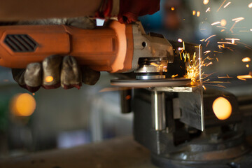 Grinding steel. Caviar from grinder. Circular saw. High speed of disk rotation. Fire from metal.