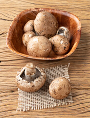Fototapeta na wymiar Portobello mushrooms in a bowl over wooden table