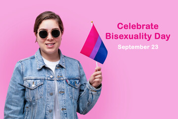 Young girl hold bisexual flag. Celebrate Bisexuality Day. - obrazy, fototapety, plakaty