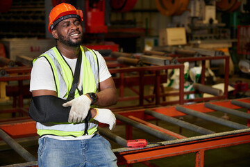 African factory workers or engineer wearing bandages splint, pain in elbow and ache in arm from...