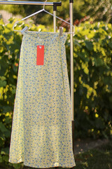 Stylish, fashionable summer dress on a hanger.