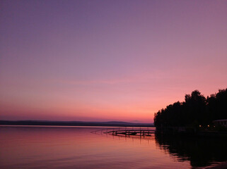 Fototapeta na wymiar Beautiful pink sunset on the lake. Nature Backgrounds