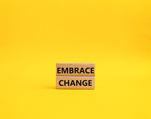 Embrace change symbol. Concept word Embrace change on wooden blocks. Beautiful yellow background. Business and Embrace change concept. Copy space