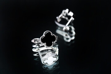 earrings with black enamel on black background - Image