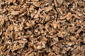 Pile of peeled raw walnut kernels, close up, background.
