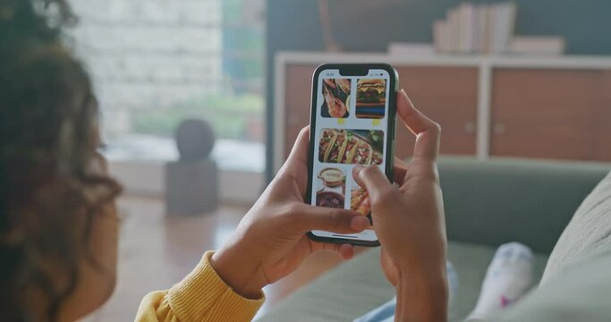 Person scrolling online menu on phone. Female hands closeup browsing food. Girl ordering food on ecommerce app