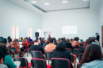 adult students in a workshop or class looking at the teacher's explanations in the classroom