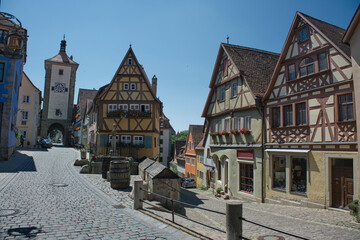 Fototapeta na wymiar Beautiful postcard view of the famous historic town of Rothenburg ob der Tauber on a sunny day with blue sky and clouds in summer, Franconia, Bavaria, Germany