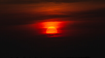 Sunset  with orange sun, red and dark sky. Zanzibar, Tanzania