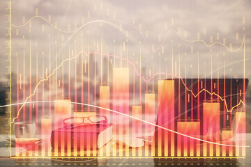 Double exposure of financial chart drawings and desk with open notebook background. Concept of forex market