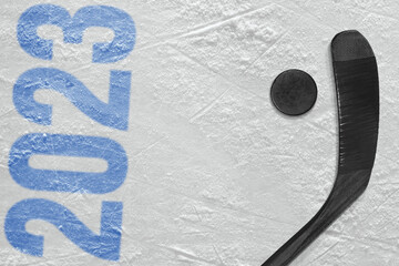 Stick, puck and a fragment of a hockey arena