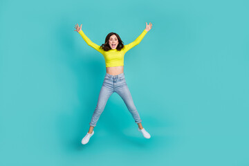 Fototapeta na wymiar Full body photo of satisfied cheerful lady jumping raise hands make star figure isolated on teal color background