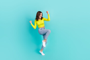 Fototapeta na wymiar Full body length photo of young attractive nice woman celebrating hands up hooray yes team winner isolated on aquamarine color background