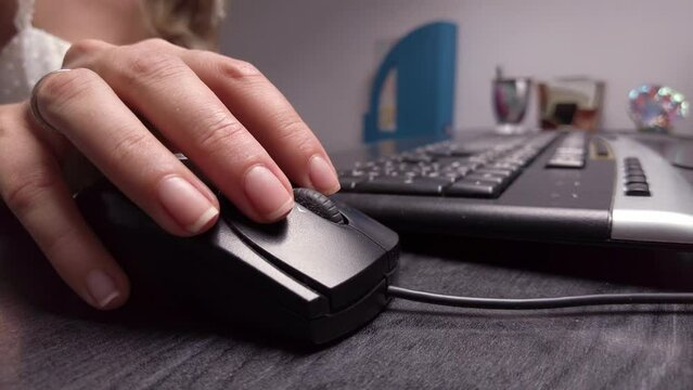 Close up woman hand working with black mouse at the office
