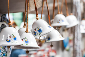 Little bells in a Kashubian composition, a souvenir from the Kashubian region in Poland. - obrazy, fototapety, plakaty