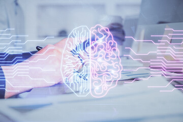 Double exposure of man's hand holding and using a digital device and brain hologram drawing. Data concept.