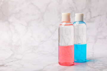 Face care for the face, tonic or lotion, micellar water on a marble background.Beauty concept.Freshness and naturalness Anti-aging care. Women's daily fresh cosmetics. Copy space. Flat lay.
