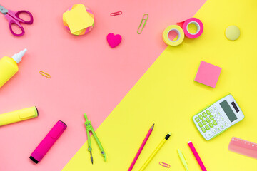 School and office supplies on a yellow-pink background