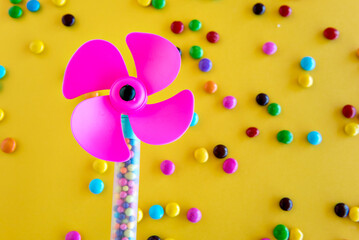 Chocolates and toys on a yellow background, happy children's day