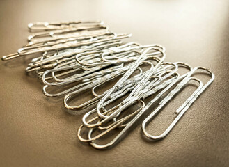 paper clips made of white metal to keep documents together in a normal way. stationery for working with documents in the office