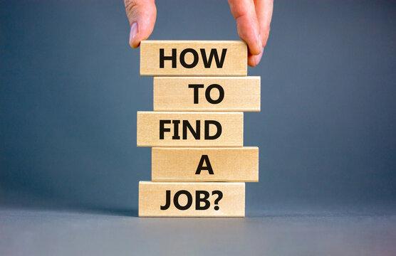 How to find a job symbol. Concept words How to find a job on wooden blocks on a beautiful grey table grey background. Businessman hand. Business and how to find a job concept. Copy space.