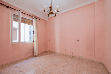 Empty room with pink painted walls, matching stoneware floors and white aluminum window