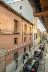 street in the center of Madrid with old buildings and traffic through the narrow streets