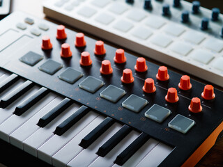 Close-up. Modern midi keyboard. Professional musical instrument for recording studio, music studio. Sound work, podcast, arrangement, music, singing.