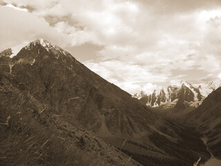 Vintage misty landscape with hills and rocks  in sepia tones.