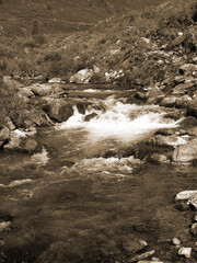 Vintage misty landscape with hills and rocks  in sepia tones.