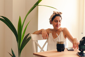 a young woman having breakfast relaxed while smiling for the camera
