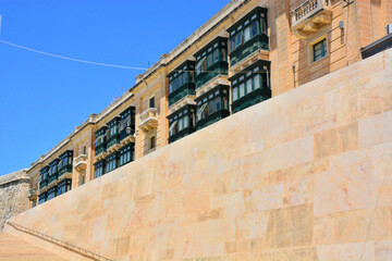 Traditional green balconies and city walls in Valletta, Malta