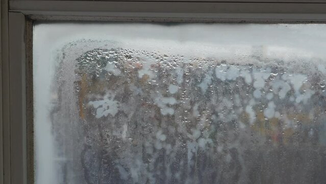 Window frame close-up showing very bad condensation within double glazing. Trapped water causing damp, mould, fogged glass and moisture damage. Housing construction problem and poor ventilation.