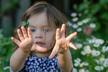 charming little girl shows something with gestures