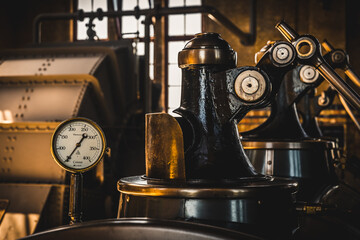 Thermometer on a hundred-year-old steam flask in a machine shop